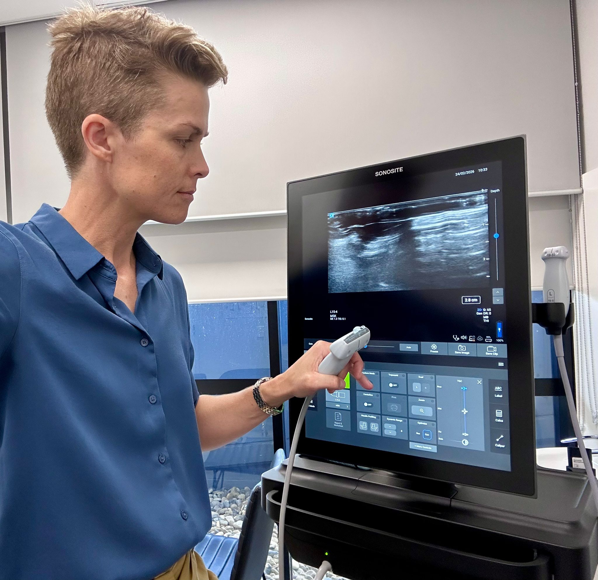 Dr Wells with ultrasound machine at SportsMed Sunshine Coast